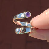 Hand of woman holding the Amethyst and Sterling Silver Adjustable Ring with One Stone and One Granule