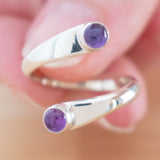 Hand of woman holding the Amethyst and Sterling Silver Adjustable Ring with Two Stones