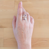 Hand of woman wearing the Amethyst and Sterling Silver Adjustable Ring with Two Stones