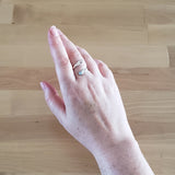 Hand of Woman Wearing Aquamarine and Sterling Silver Adjustable Ring with One Stone and One Granule