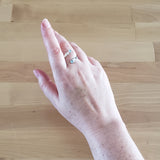 Hand of Woman Wearing Aquamarine and Sterling Silver Adjustable Ring with Two Stones