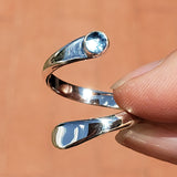 Hand of woman holding the Blue Topaz and Sterling Silver Adjustable Ring with One Stone