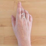 Hand of woman wearing the Blue Topaz and Sterling Silver Adjustable Ring with One Stone