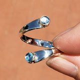 Hand of woman holding the Blue Topaz and Sterling Silver Adjustable Ring with Two Stones