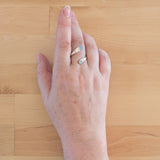 Hand of woman wearing the Blue Topaz and Sterling Silver Adjustable Ring with Two Stones