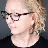 Woman Wearing the Dangle Earrings in Copper from the Bubbles Collection