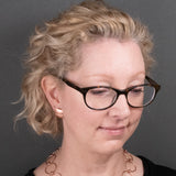 Woman wearing copper button earrings in a satin finish from Capulin Creations
