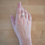 Hand of woman wearing the Carnelian and Sterling Silver Adjustable Ring with One Stone