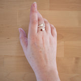 Hand of woman wearing the Carnelian and Sterling Silver Adjustable Ring with One Stone and One Granule