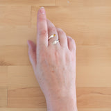 Hand of woman wearing the Citrine and Sterling Silver Adjustable Ring with One Stone