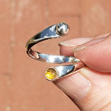 Hand of woman holding the Citrine and Sterling Silver Adjustable Ring with One Stone and One Granule