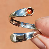 Hand of woman holding the Garnet and Sterling Silver Adjustable Ring with One Stone