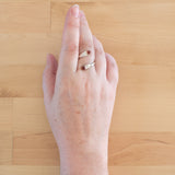 Hand of woman wearing the Garnet and Sterling Silver Adjustable Ring with Two Stones