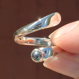 Hand of woman holding the Hematite and Sterling Silver Adjustable Ring with One Stone