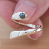 Hand of woman holding the Hematite and Sterling Silver Adjustable Ring with One Stone