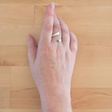 Hand of woman wearing the Hematite and Sterling Silver Adjustable Ring with One Stone