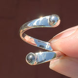 Hand of woman holding the Hematite and Sterling Silver Adjustable Ring with One Stone and One Granule