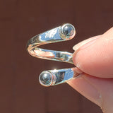 Hand of woman holding the Hematite and Sterling Silver Adjustable Ring with Two Stones