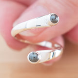 Hand of woman holding the Hematite and Sterling Silver Adjustable Ring with Two Stones