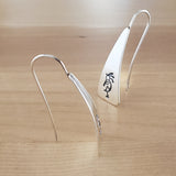 Front and Side Views of Triangle-Shaped Dangle Earrings in Sterling Silver Stamped with Kokopelli