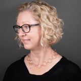Woman Wearing Chain Necklace in Copper with Large Round and Small Oval Links