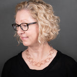 Woman Wearing Chain Necklace in Copper with Large and Small Round Links