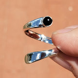Hand of woman holding the Onyx and Sterling Silver Adjustable Ring with One Stone