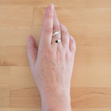 Hand of woman wearing the Onyx and Sterling Silver Adjustable Ring with One Stone