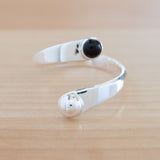 Front view of the Onyx and Sterling Silver Adjustable Ring with One Stone and One Granule