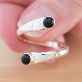 Hand of woman holding the Onyx and Sterling Silver Adjustable Ring with Two Stones