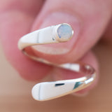 Hand of woman holding the Opal and Sterling Silver Adjustable Ring with One Stone