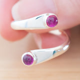 Hand of woman holding the Ruby and Sterling Silver Adjustable Ring with Two Stones