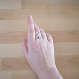 Hand of woman wearing the Sapphire and Sterling Silver Adjustable Ring with One Stone