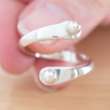 Hand of woman holding the Sterling Silver Adjustable Ring with Two Granules