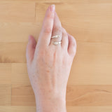 Hand of woman wearing the Sterling Silver Adjustable Ring with Two Granules