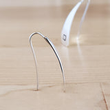 Front and side views of Triangle-Shaped Dangle Earrings in Sterling Silver stamped with squares