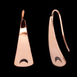 Front and side views of triangle-shaped dangle earrings stamped with sunrays in copper from Capulin Creations