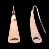 Front and side views of triangle-shaped copper earrings stamped with sunrays from Capulin Creations