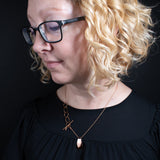 Woman wearing the Triangle Pendant Necklace in copper from Capulin Creations