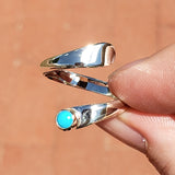 Hand of woman holding the Turquoise and Sterling Silver Adjustable Ring with One Stone