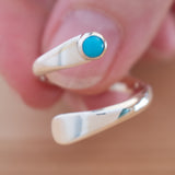 Hand of woman holding the Turquoise and Sterling Silver Adjustable Ring with One Stone