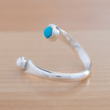 Side view of the Turquoise and Sterling Silver Adjustable Ring with One Stone and One Granule