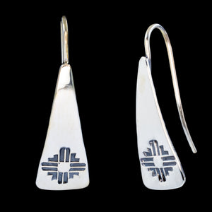 Front and side views of triangle-shaped sterling silver earrings stamped with Zia sun symbols from Capulin Creations
