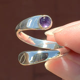 Hand of woman holding the Amethyst and Sterling Silver Adjustable Ring with One Stone