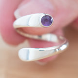 Hand of woman holding the Amethyst and Sterling Silver Adjustable Ring with One Stone