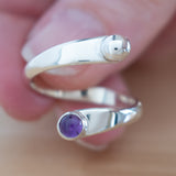 Hand of woman holding the Amethyst and Sterling Silver Adjustable Ring with One Stone and One Granule