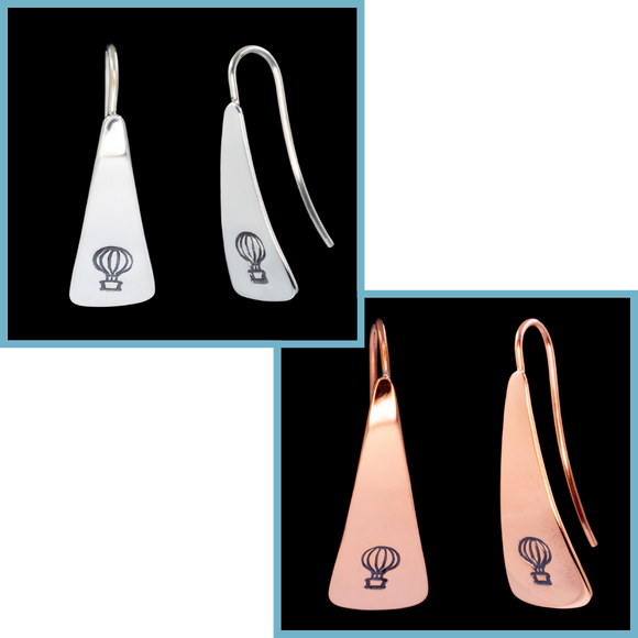 Front and side views of triangle-shaped sterling silver and copper earrings stamped with hot air balloons from Capulin Creations