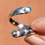 Hand of woman holding the Blue Topaz and Sterling Silver Adjustable Ring with One Stone and One Granule