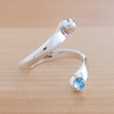 Side view of the Blue Topaz and Sterling Silver Adjustable Ring with One Stone and One Granule