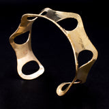 Side view of hammered brass cuff bracelet with ovals from Capulin Creations